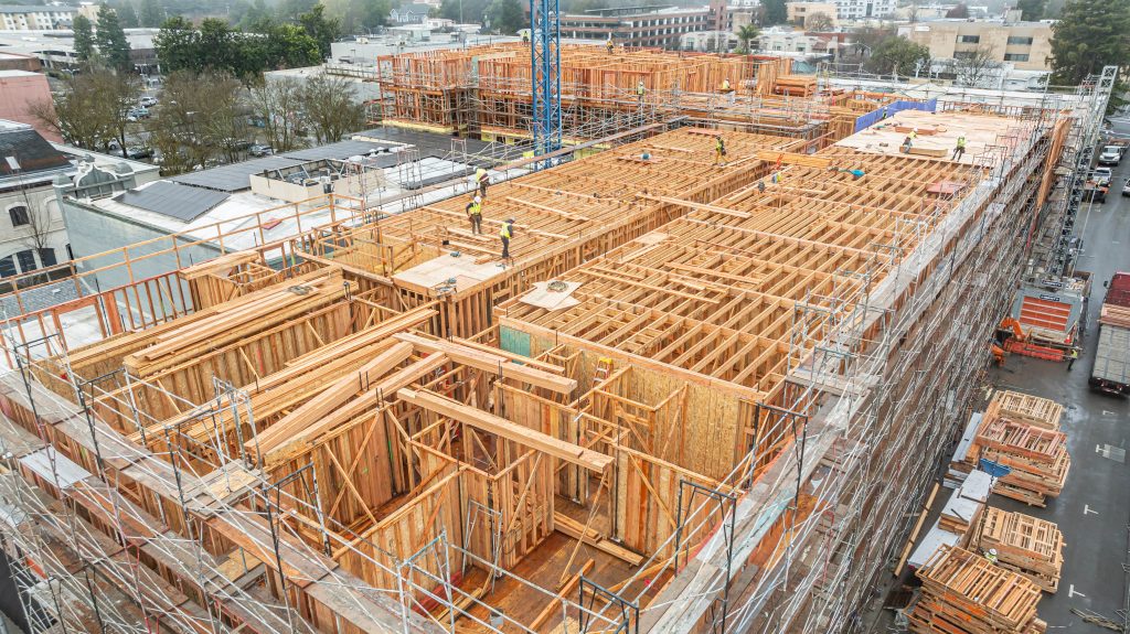 Timber framework under construction with visible wooden supports and scaffolding