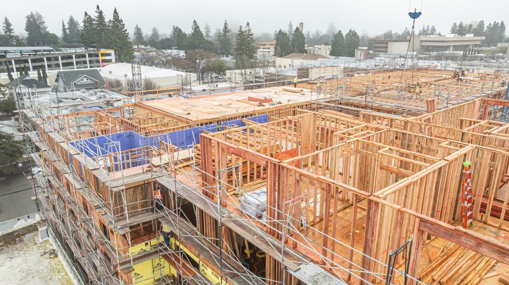 Construction site showing a wooden frame with structural beams and supports