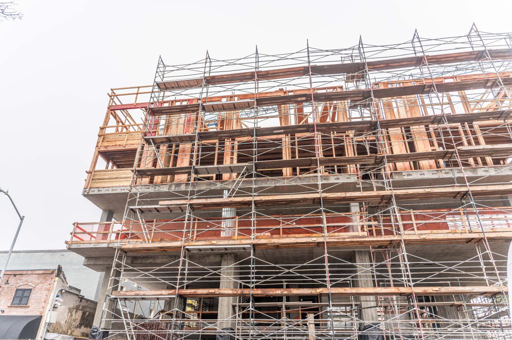 Partially assembled timber framework featuring wooden beams and support posts