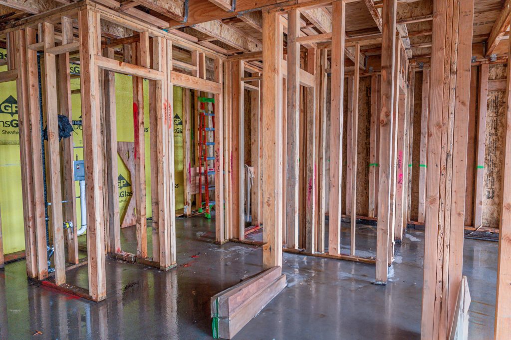 Wooden frame with exposed rafters and construction materials visible on-site