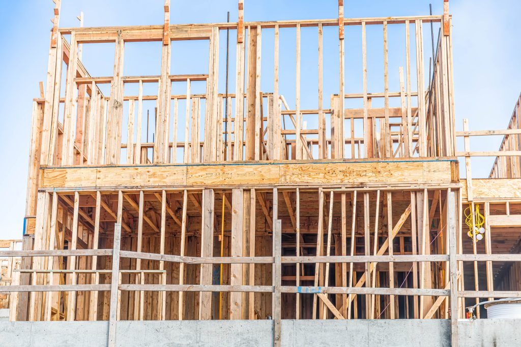 Timber frame of a building with construction scaffolding and visible support beams.