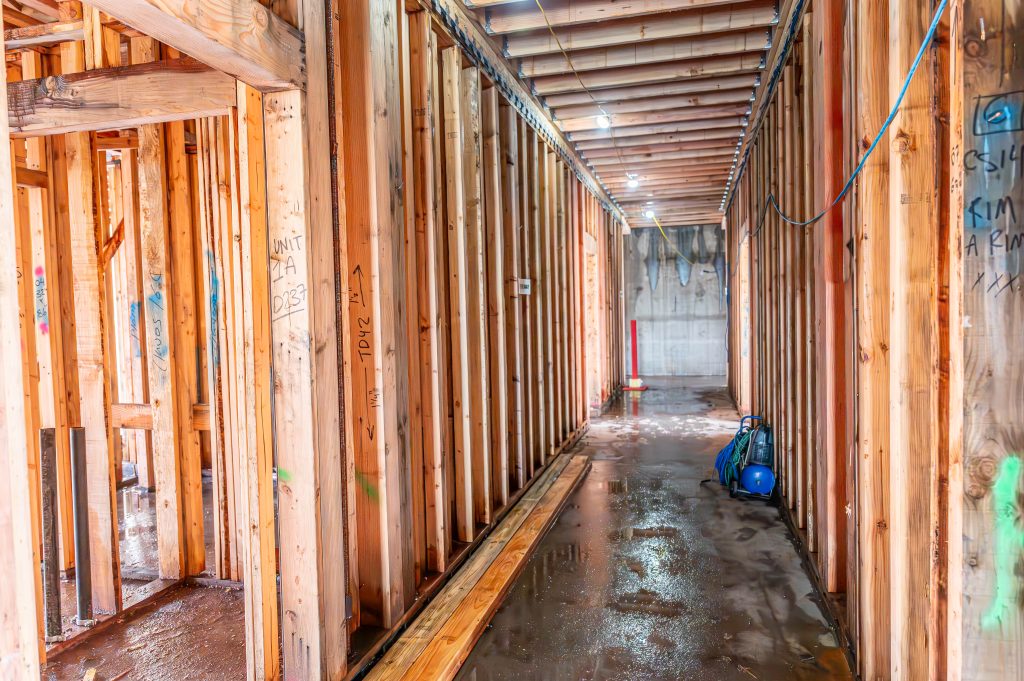 Partially built wooden frame with detailed timber joints and structural elements.