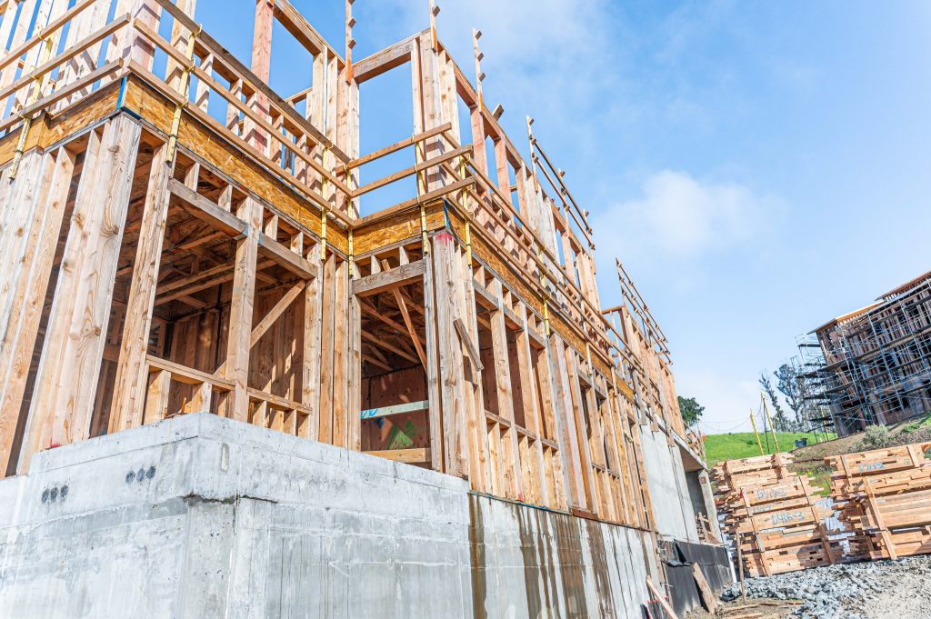 Wooden framework with exposed columns and beams during building assembly
