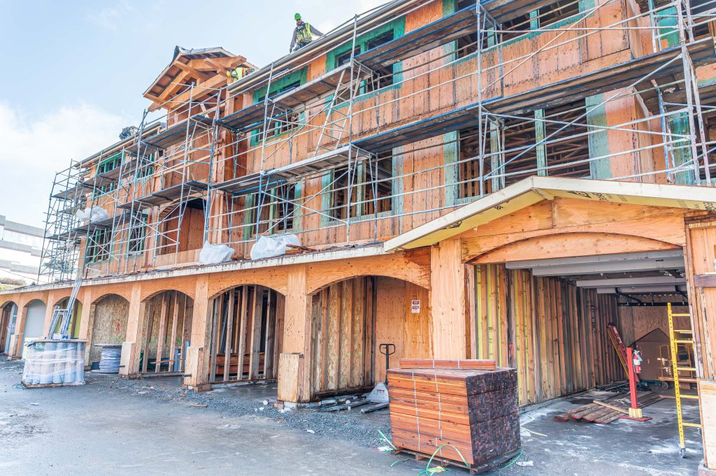 Construction site with wooden frame and scaffolding, highlighting structural timber