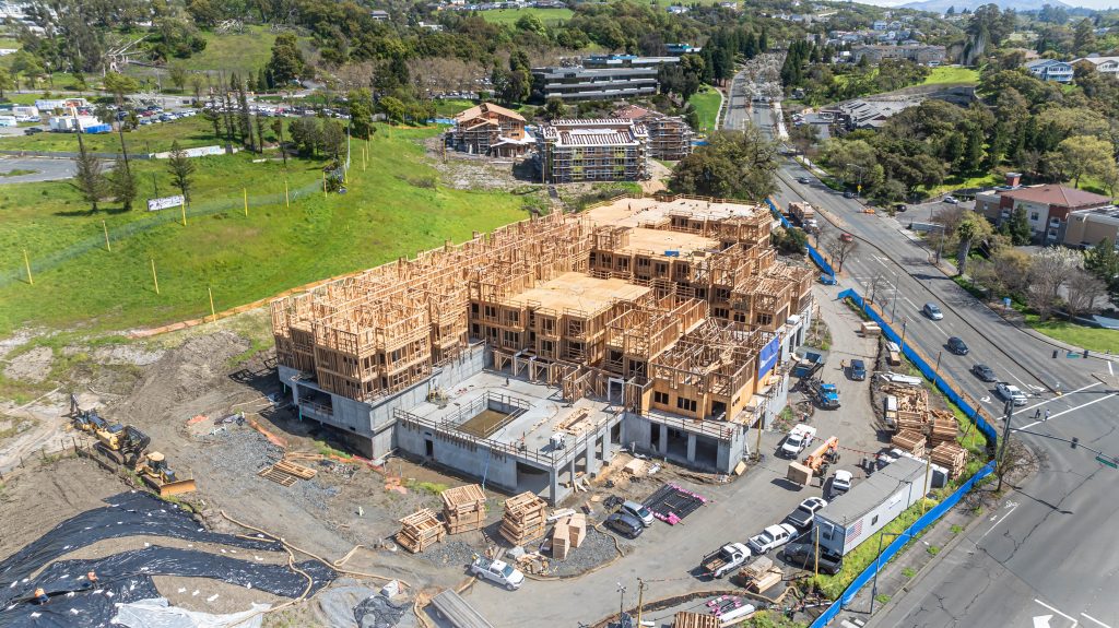Construction site displaying a wooden frame with exposed timber joints and structural components.