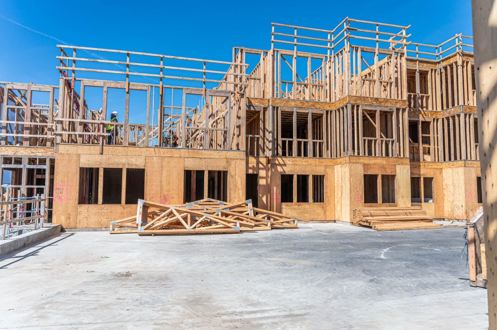 Scaffolded wooden structure featuring timber beams and columns arranged for construction