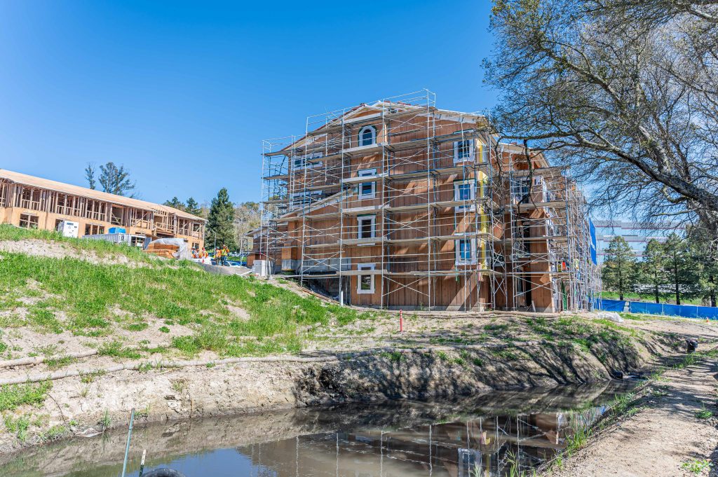 Wooden building frame in progress, with visible horizontal and vertical wooden supports.