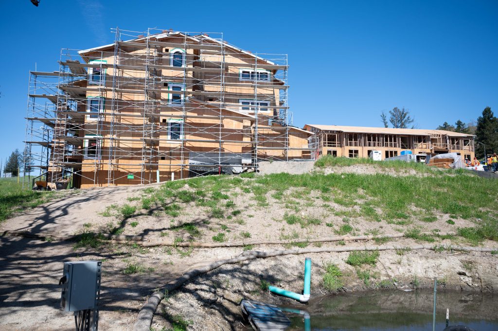 Timber framework for a new building, highlighting wooden beams, posts, and construction tools