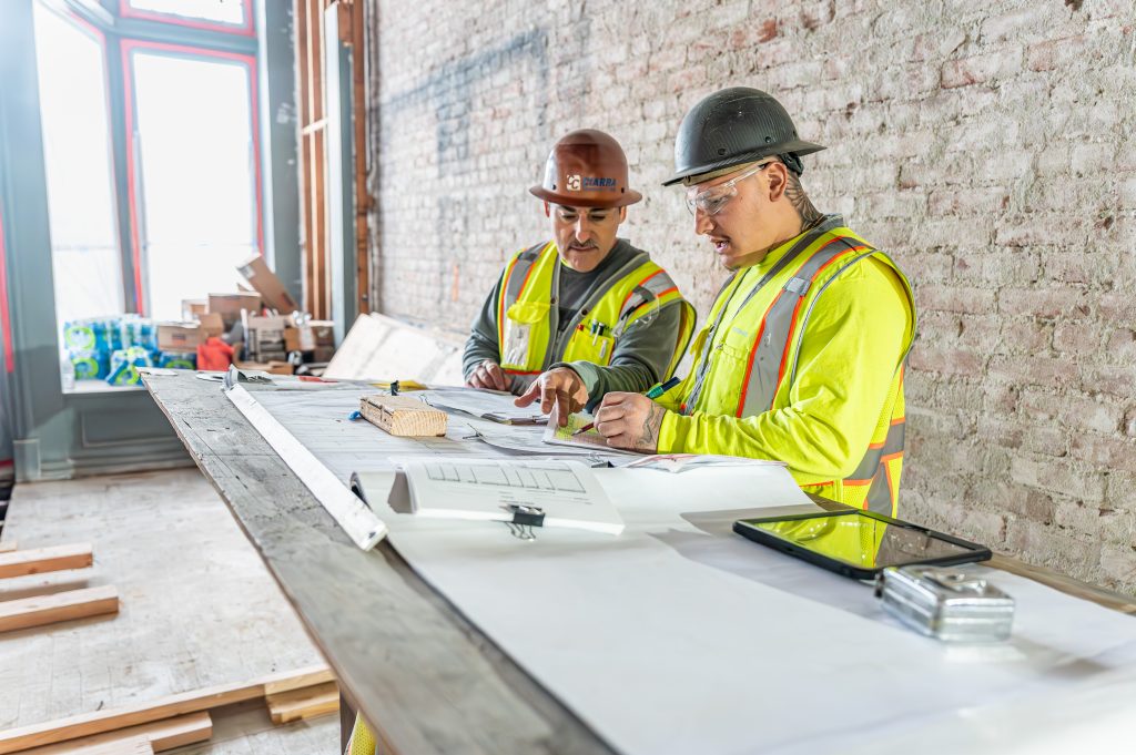 Worker placing wooden beams carefully to build a strong frame.