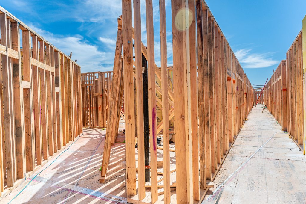 Wooden skeletal framework of a new building, showcasing horizontal and vertical timber elements