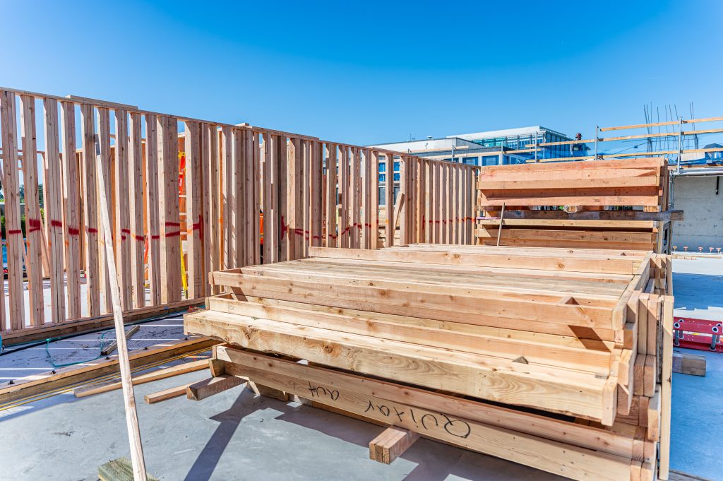 Wooden structural framework of a building with exposed timber and construction materials