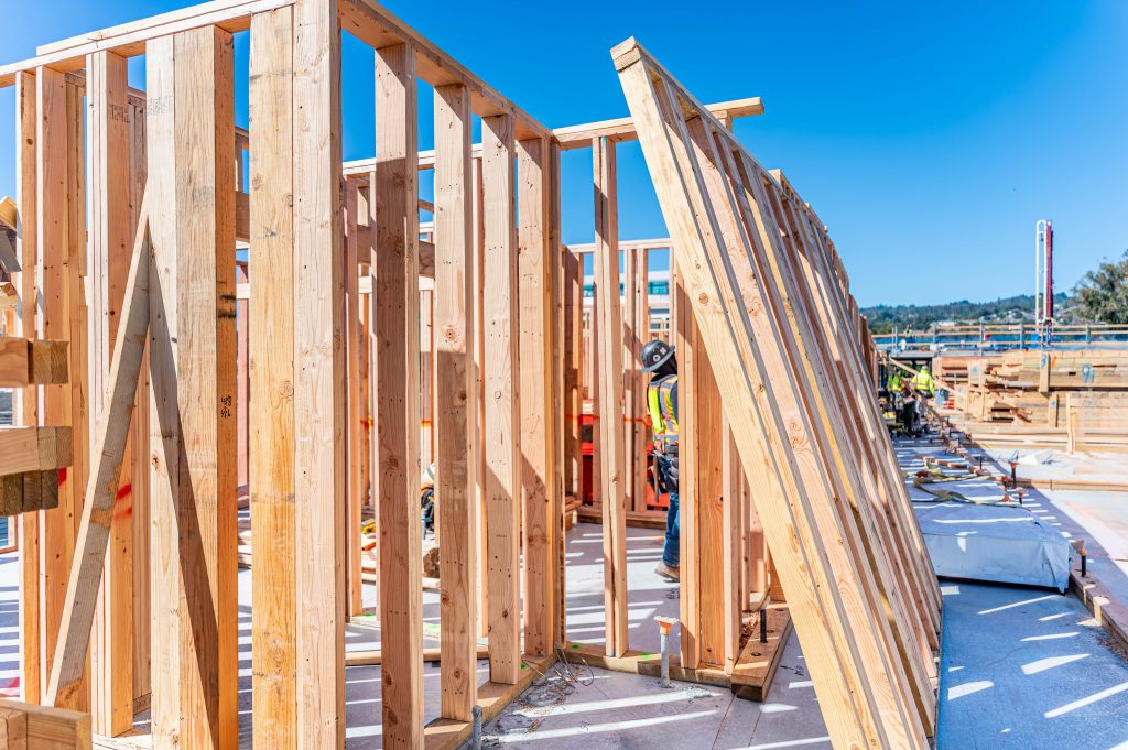 Construction site displaying a wooden frame with beams and supports being assembled