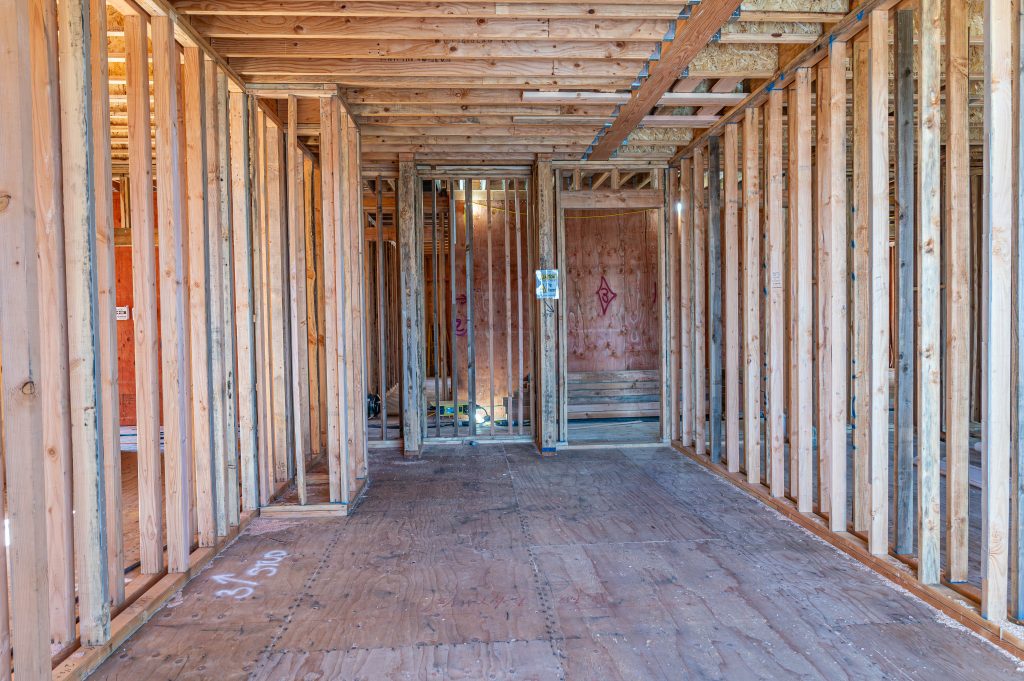 Timber construction site with wooden framework forming the skeleton of a new structure