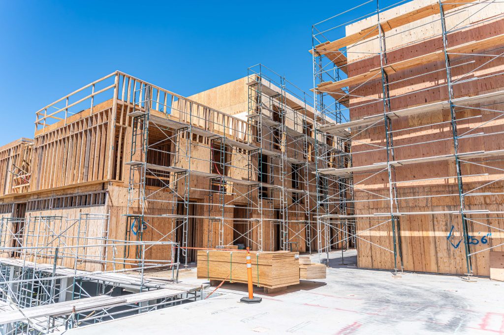 Construction site with wooden frame in progress, highlighting the structure’s basic form.