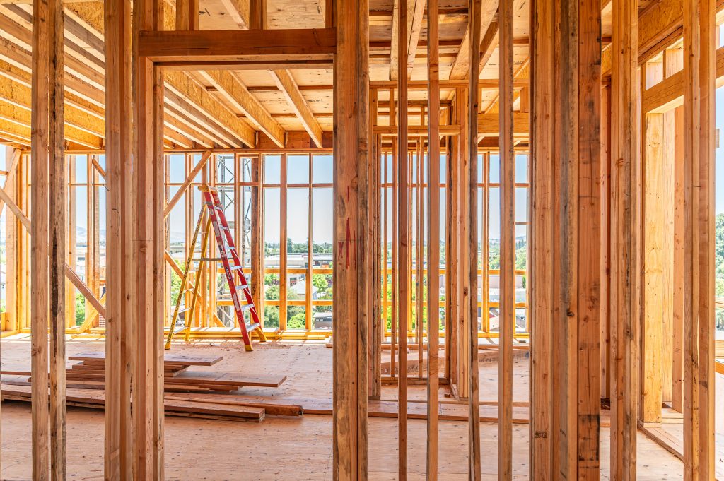 Partially built wooden frame structure showcasing a series of vertical and horizontal supports