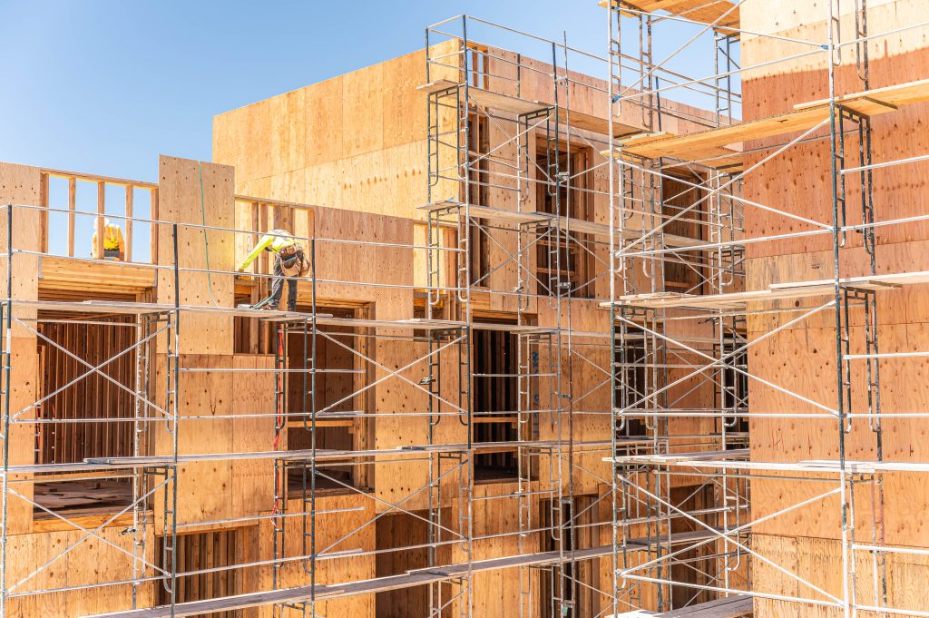Wooden building frame under construction with exposed beams and columns